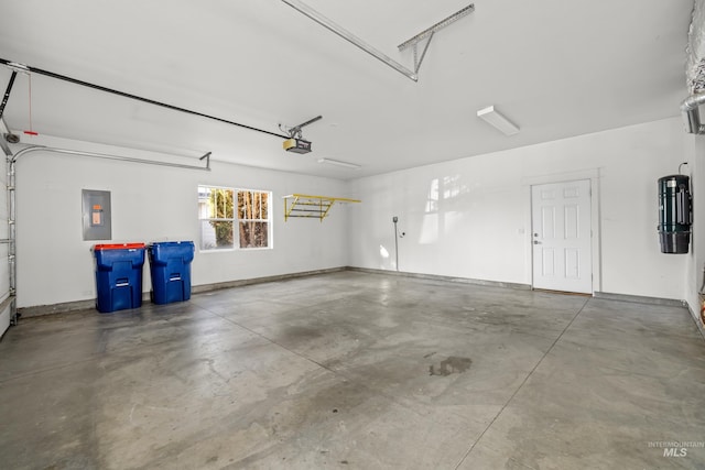 garage featuring a garage door opener and electric panel