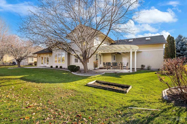 rear view of property with a yard, a pergola, and a patio area