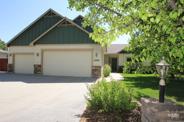 1491 N Millstream Ct, Nampa, ID 83686 - view of front of home with stone siding, board and batten siding, an attached garage, and concrete driveway