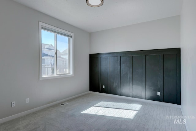 unfurnished bedroom with visible vents, baseboards, and carpet flooring