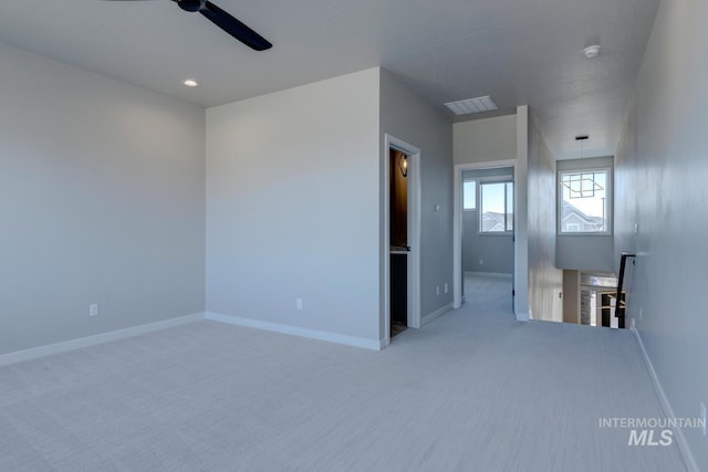 unfurnished room featuring carpet, visible vents, and baseboards