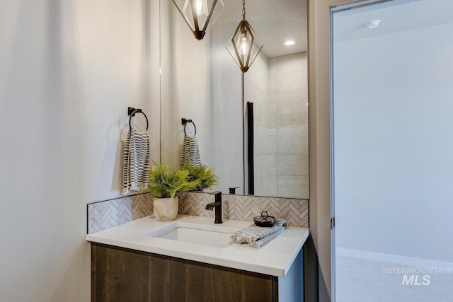 bathroom with tasteful backsplash and vanity