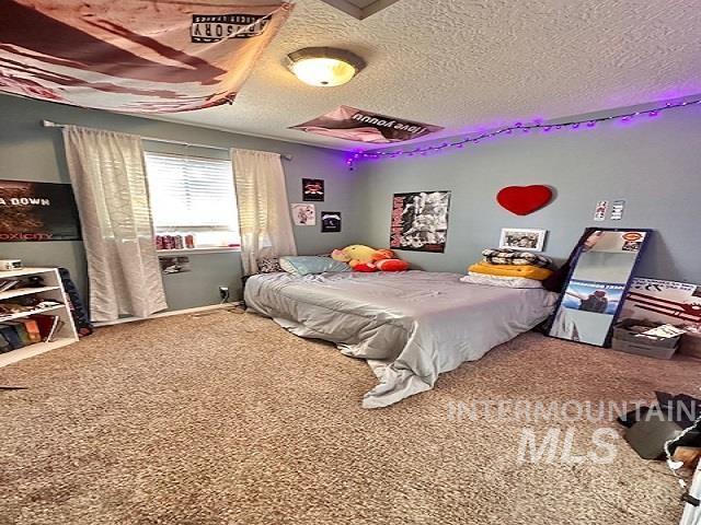 carpeted bedroom with a textured ceiling