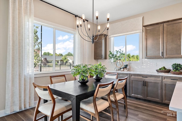 5420 W Double Blue St, Eagle, ID 83616 - dining area featuring healthy amount of natural light, a chandelier, and dark wood-style flooring