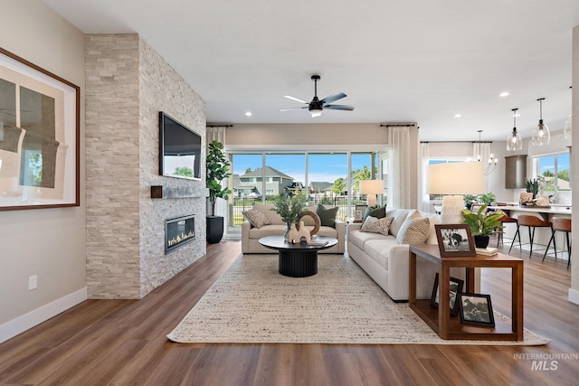 5420 W Double Blue St, Eagle, ID 83616 - living area featuring a stone fireplace, ceiling fan, wood finished floors, baseboards, and recessed lighting