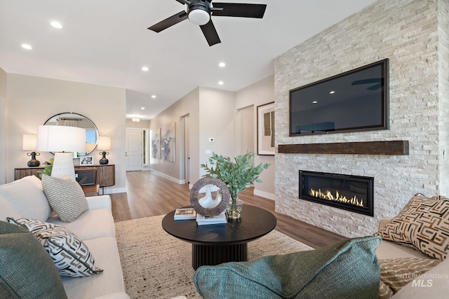 5420 W Double Blue St, Eagle, ID 83616 - living room featuring wood finished floors, a ceiling fan, a stone fireplace, baseboards, and recessed lighting