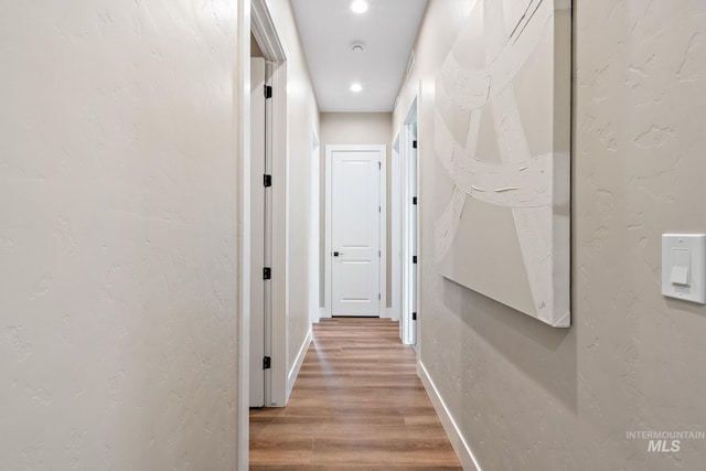 5420 W Double Blue St, Eagle, ID 83616 - hall featuring light wood finished floors, baseboards, and recessed lighting
