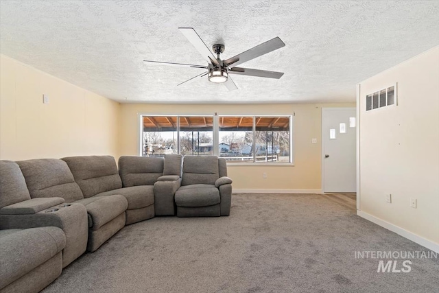 living room with light colored carpet, ceiling fan, and a textured ceiling