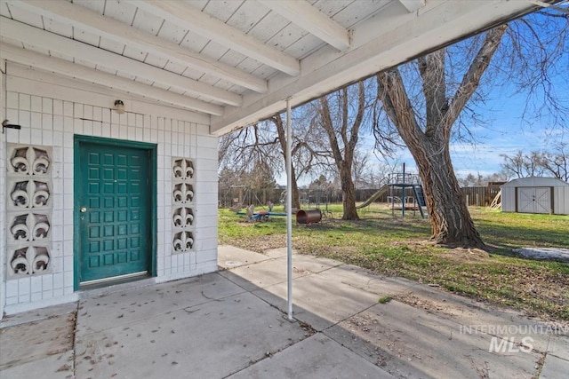 exterior space featuring a storage shed and a playground