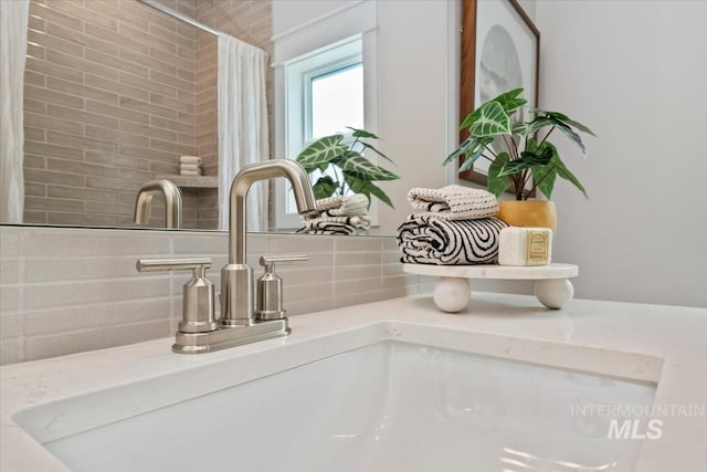 8469 W Happy Day Dr, Meridian, ID 83646 - bathroom view of a sink, backsplash, and a shower with curtain