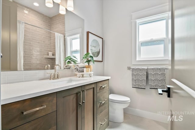8469 W Happy Day Dr, Meridian, ID 83646 - full bath with toilet, vanity, curtained shower, and baseboards