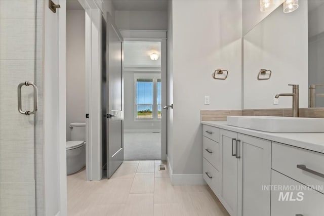 8469 W Happy Day Dr, Meridian, ID 83646 - bathroom with vanity, toilet, and baseboards