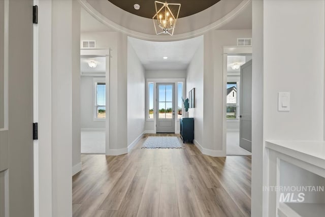8469 W Happy Day Dr, Meridian, ID 83646 - entrance foyer with light wood-style flooring, plenty of natural light, baseboards, and a chandelier