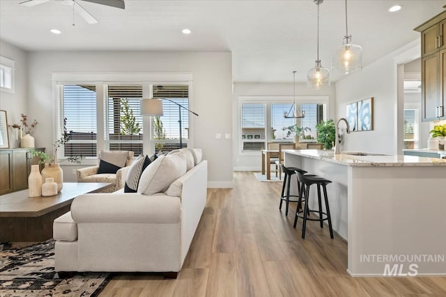 8469 W Happy Day Dr, Meridian, ID 83646 - living room featuring light wood finished floors, plenty of natural light, ceiling fan, and recessed lighting
