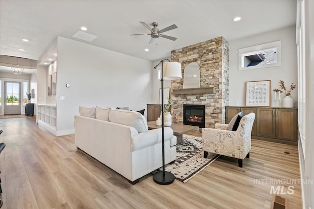 8469 W Happy Day Dr, Meridian, ID 83646 - living room featuring a fireplace, light wood finished floors, ceiling fan, recessed lighting, and baseboards