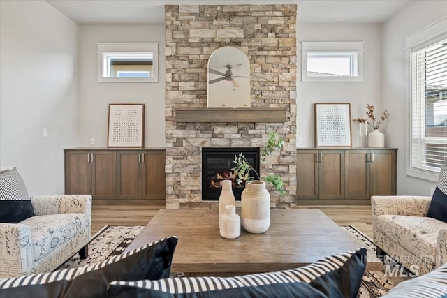 8469 W Happy Day Dr, Meridian, ID 83646 - living area featuring light wood-type flooring, ceiling fan, and a fireplace