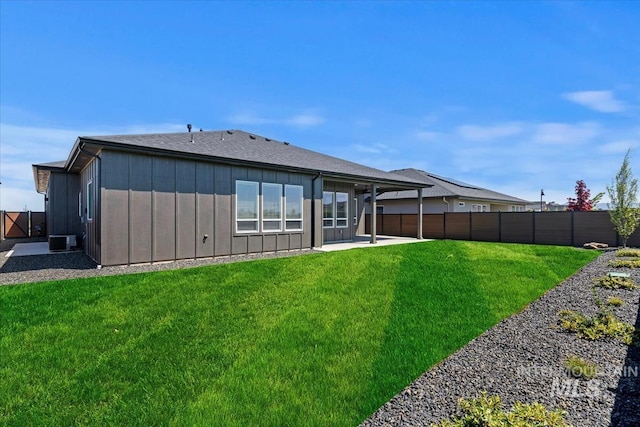 8469 W Happy Day Dr, Meridian, ID 83646 - rear view of property with board and batten siding, a patio, and central AC