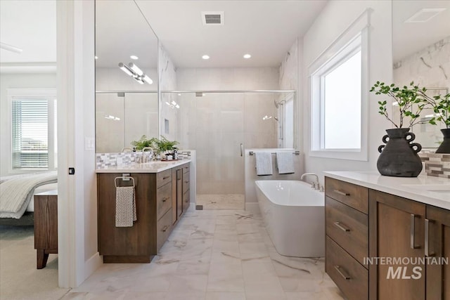 8469 W Happy Day Dr, Meridian, ID 83646 - ensuite bathroom with a stall shower, a soaking tub, vanity, marble look tiles, and recessed lighting