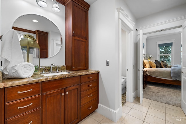 876 E Pennsylvania Ln, Boise, ID 83706 - ensuite bathroom featuring tile patterned flooring, vanity, toilet, and baseboards