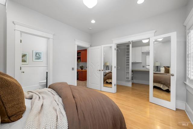 876 E Pennsylvania Ln, Boise, ID 83706 - bedroom with a walk in closet, light wood-type flooring, ensuite bathroom, a closet, and baseboards