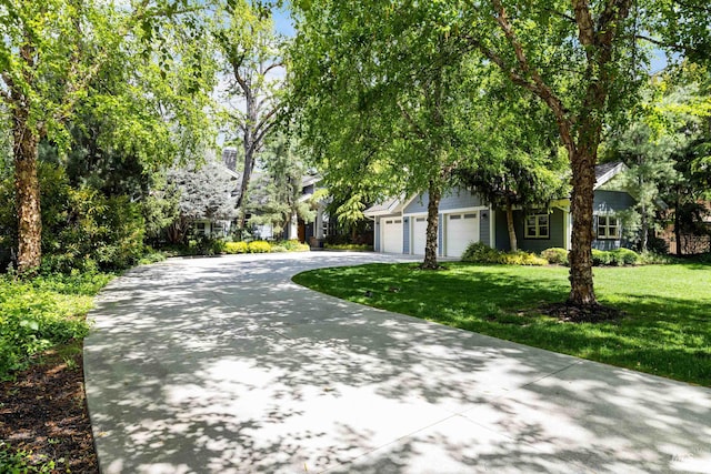 876 E Pennsylvania Ln, Boise, ID 83706 - obstructed view of property featuring concrete driveway, a front lawn, and an attached garage
