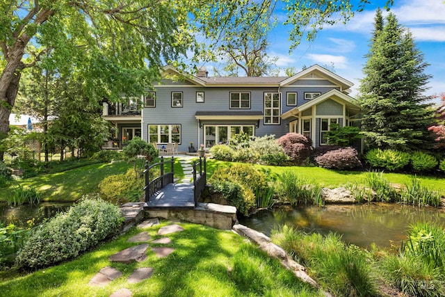876 E Pennsylvania Ln, Boise, ID 83706 - rear view of property featuring a lawn, a garden pond, and a balcony