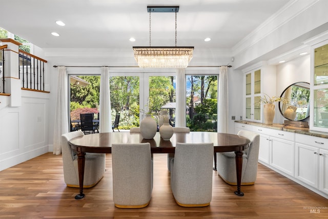 876 E Pennsylvania Ln, Boise, ID 83706 - dining space featuring crown molding, a chandelier, wood finished floors, a decorative wall, and recessed lighting