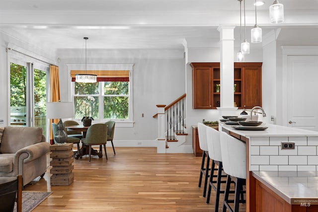 876 E Pennsylvania Ln, Boise, ID 83706 - dining space with light wood-type flooring, stairway, plenty of natural light, crown molding, and baseboards