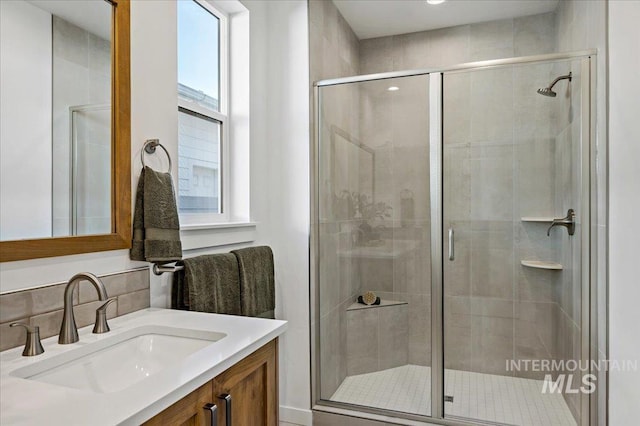 full bathroom with vanity and a shower stall