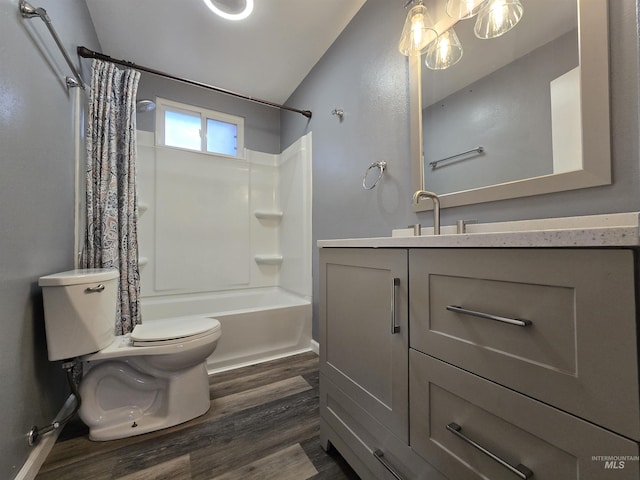 bathroom with toilet, shower / bath combo, wood finished floors, vanity, and vaulted ceiling