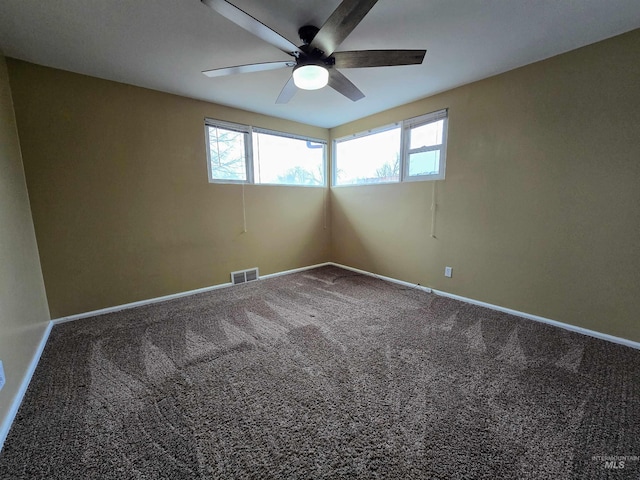 carpeted empty room featuring a ceiling fan, baseboards, and visible vents