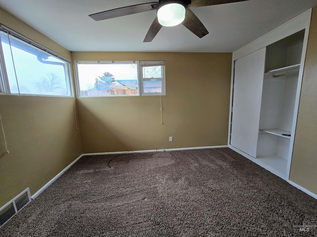 unfurnished bedroom featuring visible vents, baseboards, ceiling fan, carpet flooring, and a closet