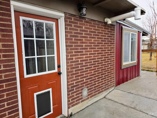 property entrance with brick siding