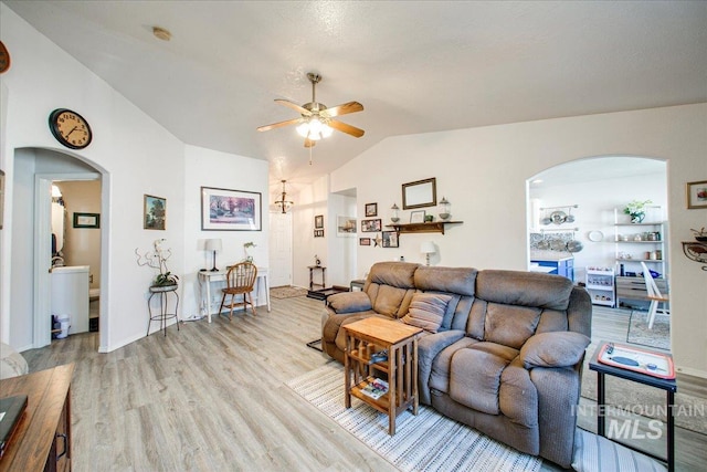 living room featuring light hardwood / wood-style flooring, lofted ceiling, and ceiling fan