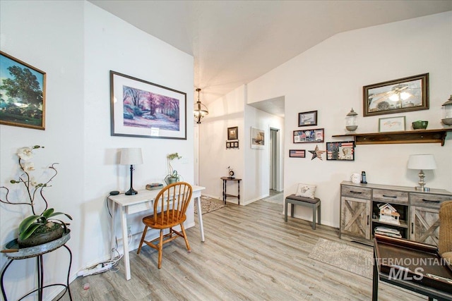 office space featuring light wood-type flooring and vaulted ceiling