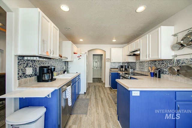 kitchen featuring light wood-type flooring, white cabinetry, a textured ceiling, and dishwasher