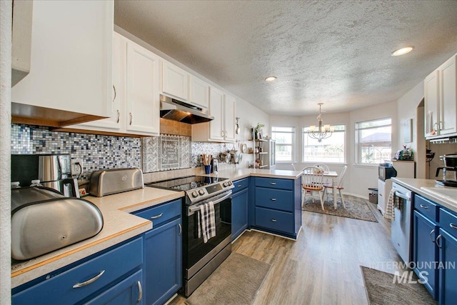 kitchen featuring decorative light fixtures, blue cabinetry, stainless steel appliances, and white cabinets