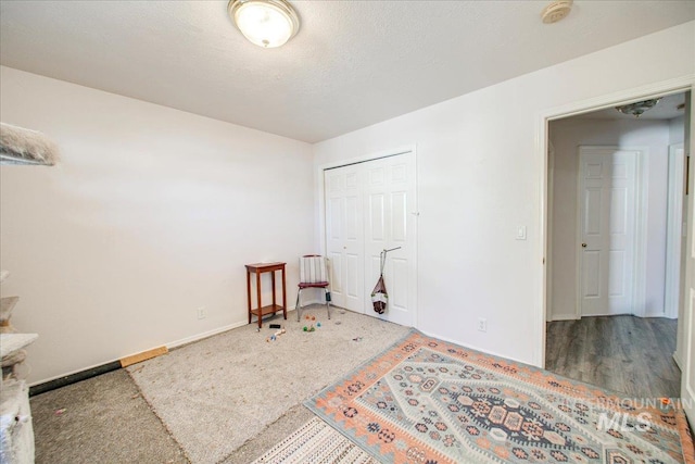 bedroom featuring a textured ceiling, hardwood / wood-style flooring, and a closet