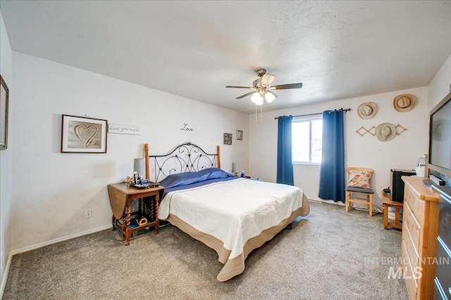 bedroom featuring a textured ceiling, carpet, and ceiling fan