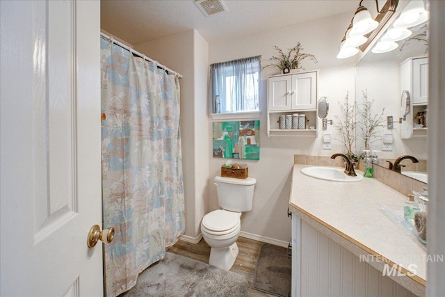 bathroom with hardwood / wood-style flooring, vanity, and toilet