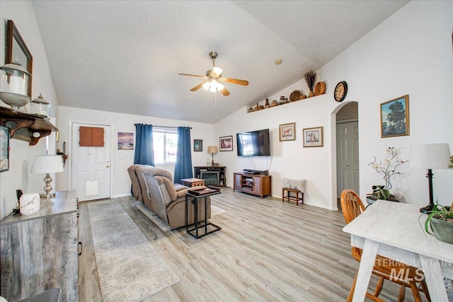 living room with light wood-type flooring, lofted ceiling, and ceiling fan