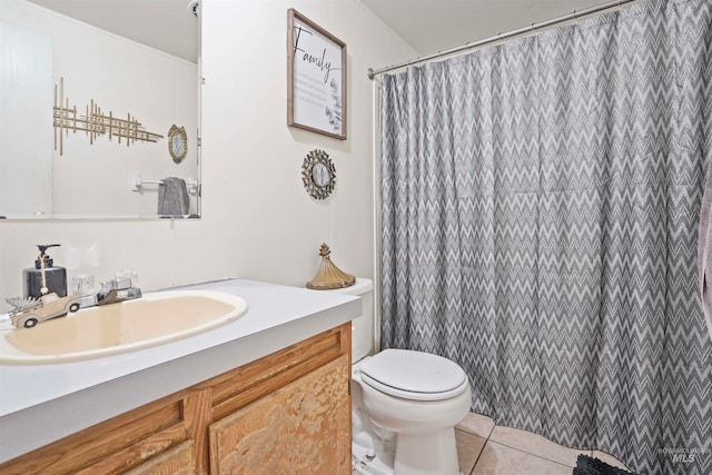 bathroom featuring walk in shower, vanity, toilet, and tile patterned floors