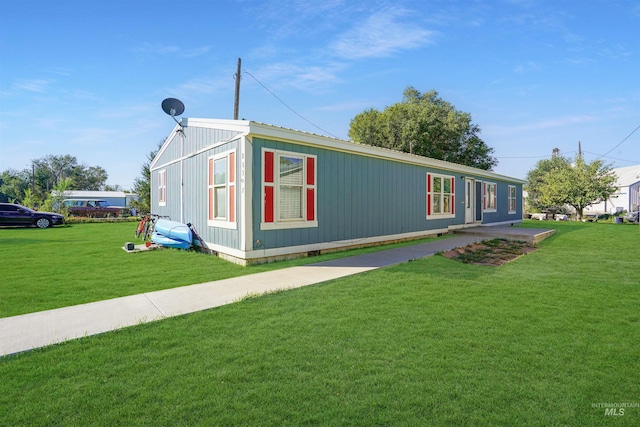 view of side of property featuring a yard