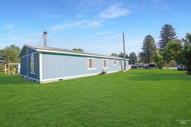 view of side of home featuring a lawn