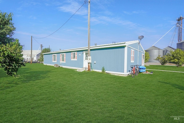 rear view of house with a yard