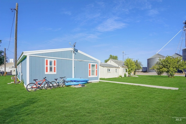 rear view of property featuring a yard