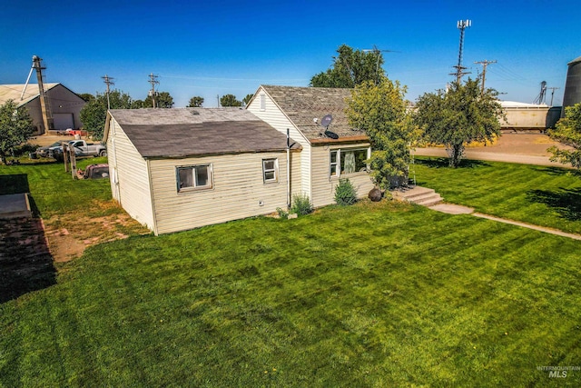 back of property featuring a lawn