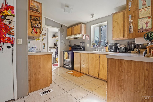 kitchen with stainless steel electric range oven and light tile patterned floors