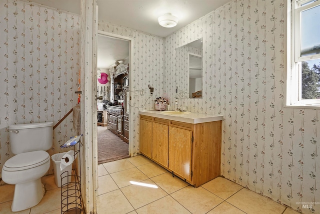 bathroom with vanity, tile patterned floors, and toilet