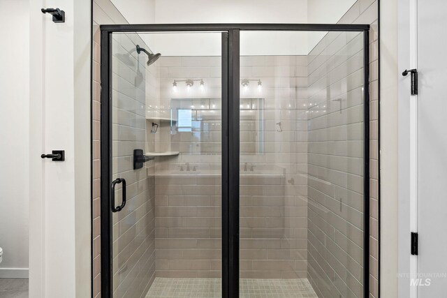 bathroom featuring a shower stall and toilet